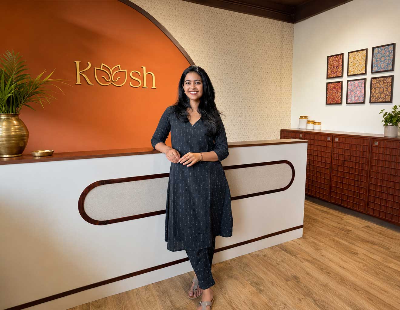 Woman standing in a room with a 'Koosh' branded counter